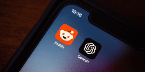 Close-up of a smartphone screen displaying the Reddit and OpenAI app icons.