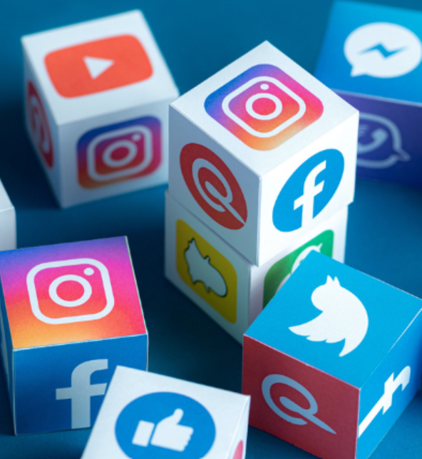 Colorful cubes with icons of social media platforms, including Instagram, Facebook, Twitter, and YouTube, on a blue background.