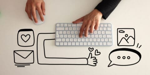 Hands using a computer mouse and keyboard with doodle illustrations of an envelope, a thumbs-up, a heart, an image, and a speech bubble.