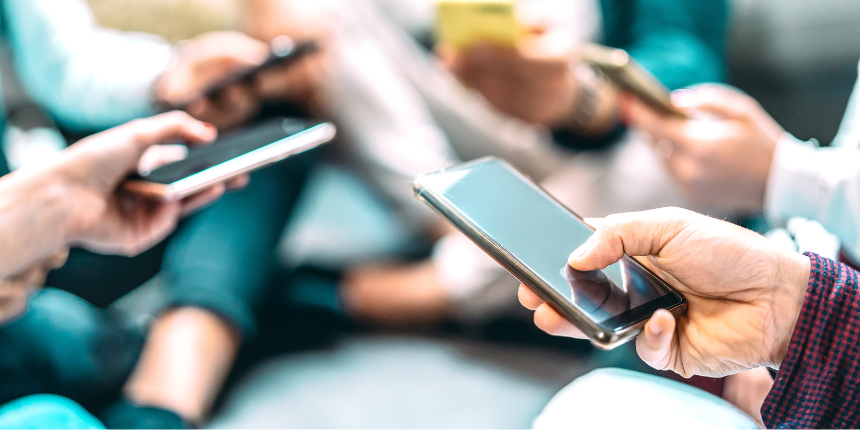 People holding smartphones and using them in a social setting.