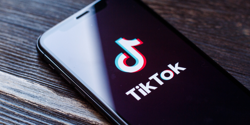 Close-up of a smartphone displaying the TikTok logo on the screen.