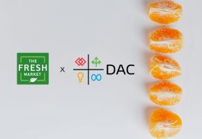 "The Fresh Market x DAC" logos on a white background next to a vertical row of five orange slices.