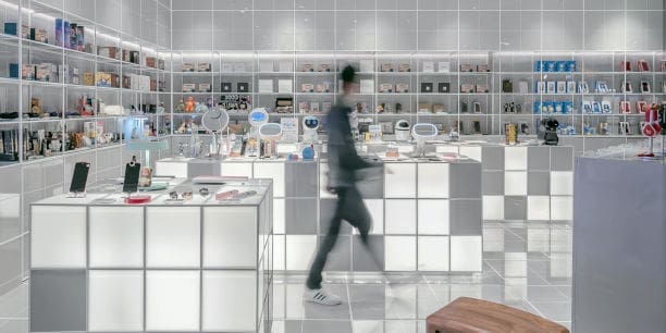 Man walking across the shop floor of an electronics store