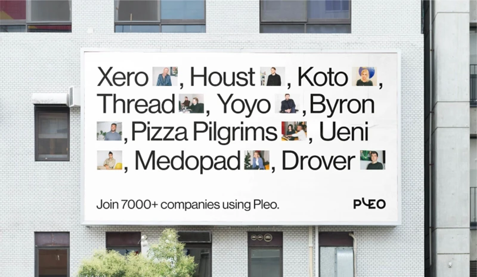 Alt text: A billboard on a building advertising Pleo with company names such as Xero, Houst, Koto, Thread, Yoyo, Byron, Pizza Pilgrims, Ueni, Medopad, and Drover, featuring images of people next to each name. Text reads: "Join 7000+ companies using Pleo."