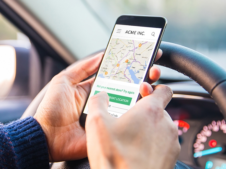 Driver checking directions to a store using her smartphone