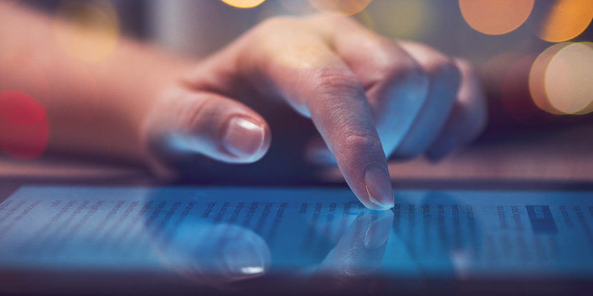 Woman's hand scrolling down a tablet screen