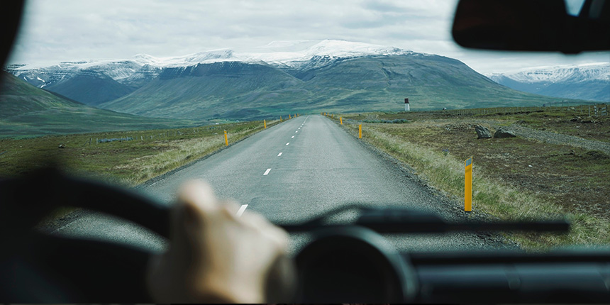 Vue d'une route menant aux montagnes depuis le siège du conducteur d'une voiture