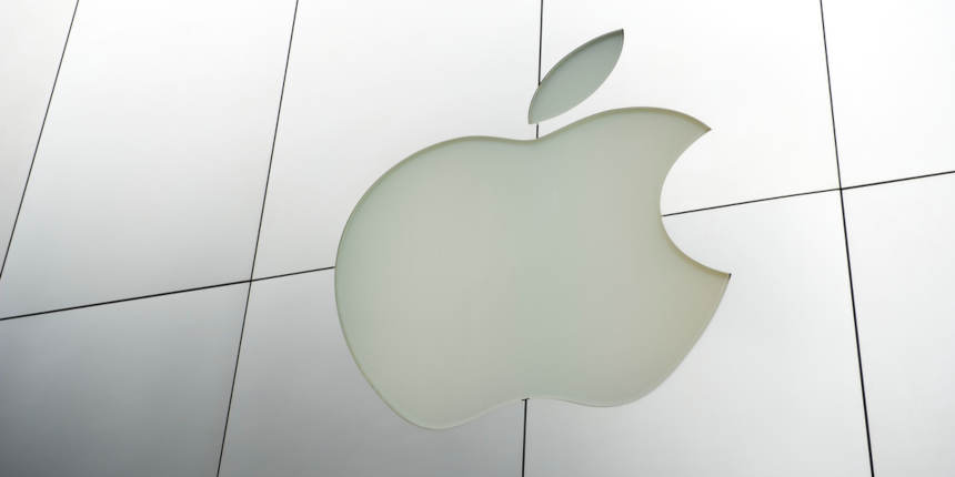 Apple Computers logo sits in brushed metal facade of a store in Union Square.