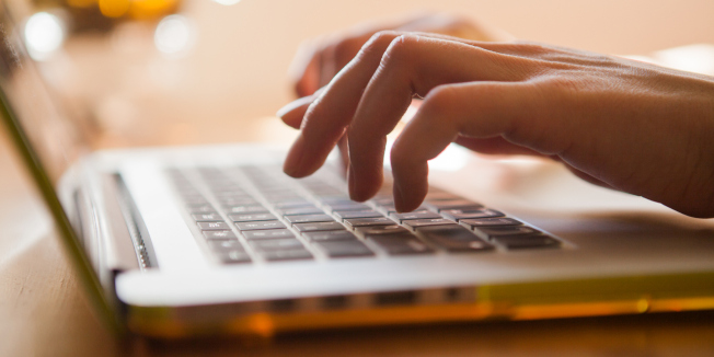 Woman is typing on the laptop